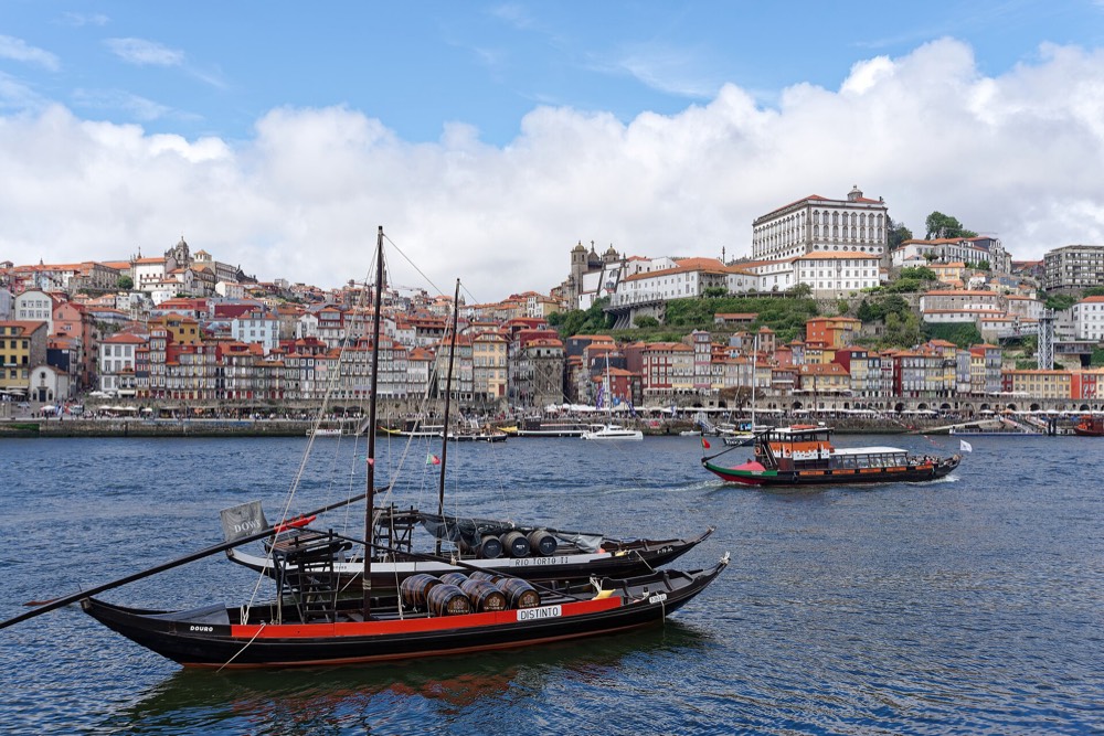 Rabelo boats on the Douro in front of the colourful houses of Ribeira, Porto